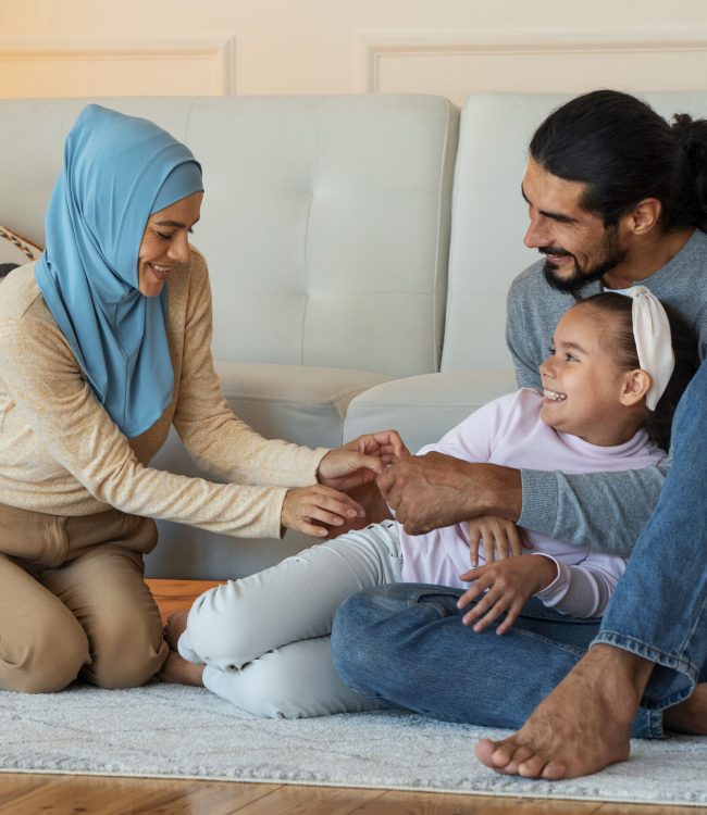 happy-islamic-family-sitting-floor-full-shot